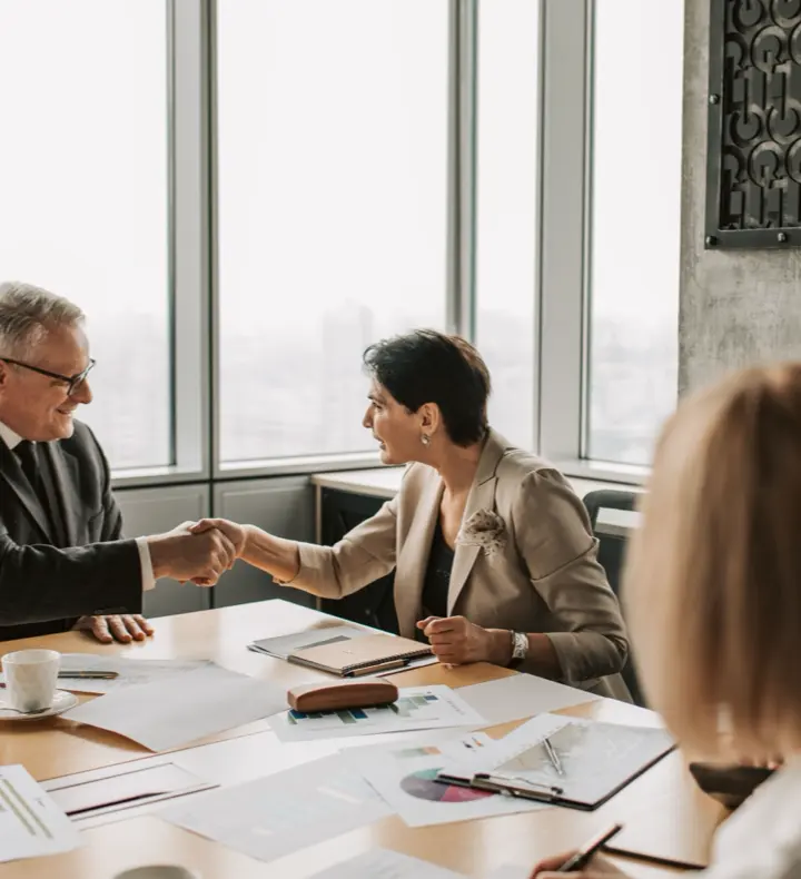 Colleagues shaking hands during a formal business meeting.