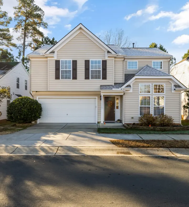 A two-storey American suburban rental house seen from the street.